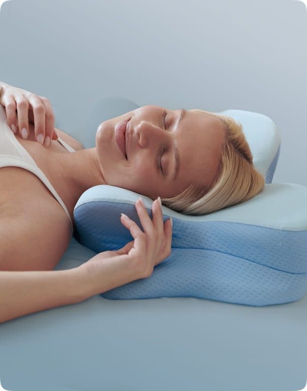 Close-up of a woman resting her head and neck on the Derila Ergo pillow's contoured foam